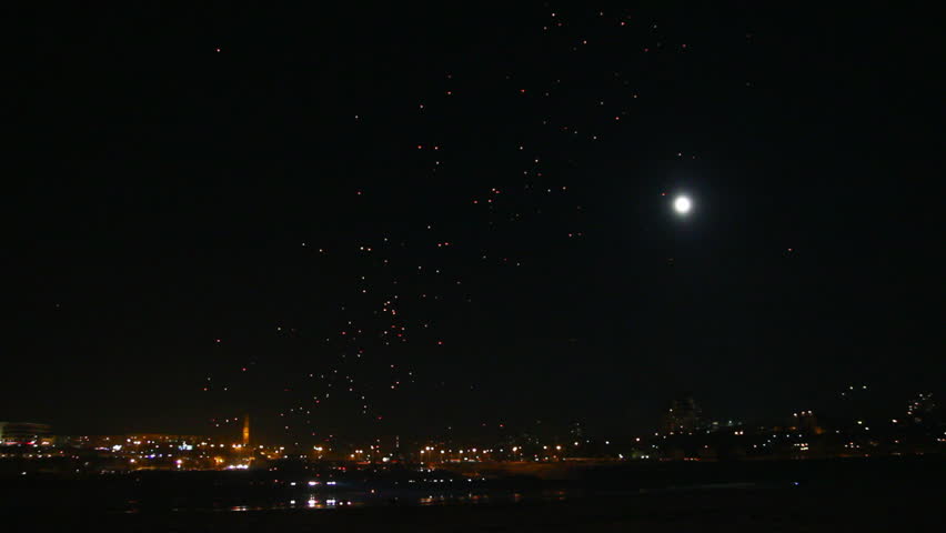 many Japanese Lantern flies over city at night