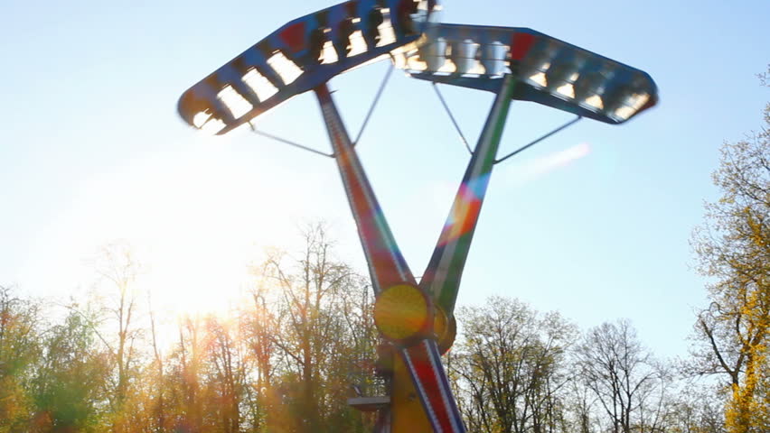 big swing in park against sun