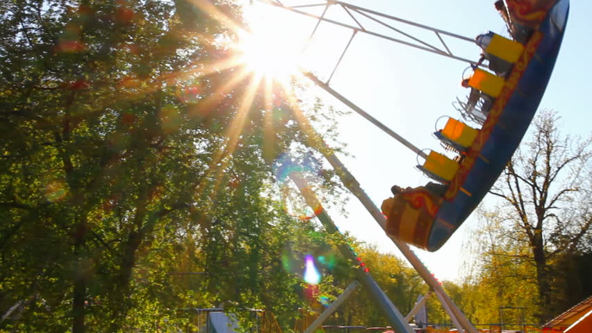 big swing in park against sun