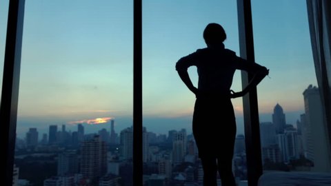 Young businesswoman admire cityscape at night, slow motion
