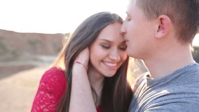 Beautiful Young Couple in Love kiss in the sun