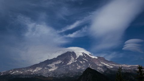 4K Time lapse of clouds passing the peak of Mount Rainier, Washington with a blue sky at daytime