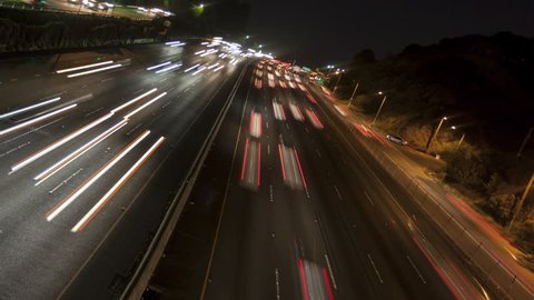 4K Time lapse rotate night motion light trails on a busy Los Angeles freeway