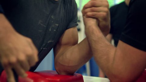 Intense struggle at arm-wrestling competition close-up