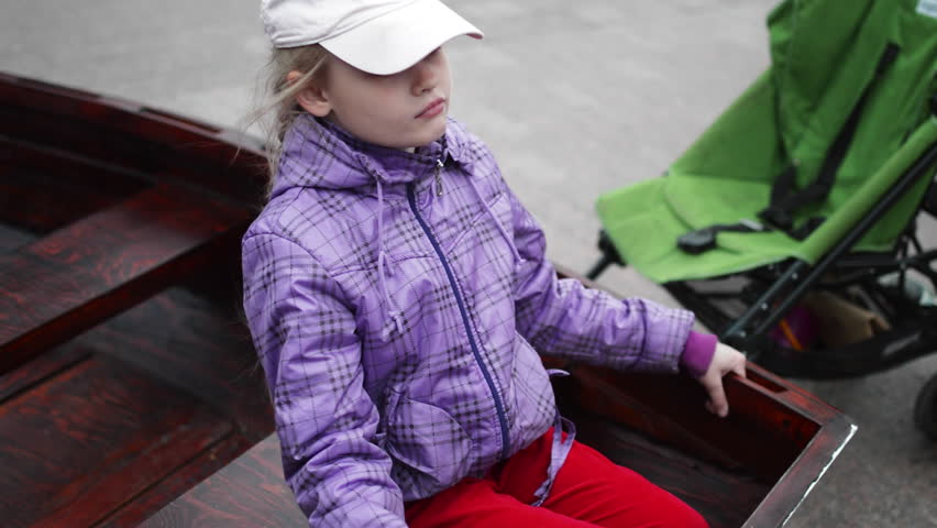 Girl Sitting in a Wooden Boat hd