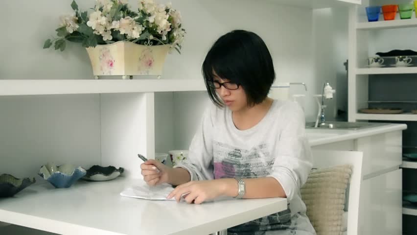 An Asian Thai girl writing something on the paper and screw up with sulky temper in HD

