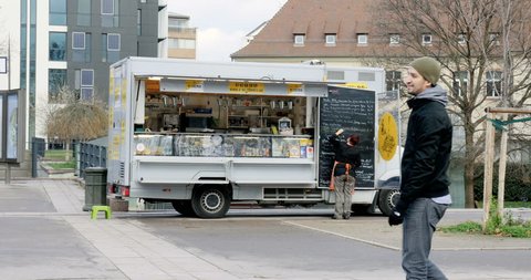 STRASBOURG, FRANCE - CIRCA 2016: Woman writing the menu near the food truck chef own in the center of Strasbourg, France