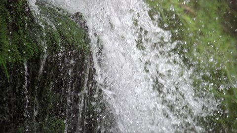 slow motion waterfall durung spring in the italian alps