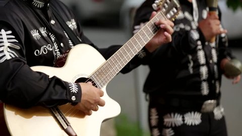 Mexican musicians mariachi on the street. Close-up of hands