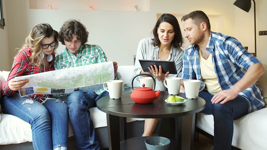 Friends using map and tablet and exchange it with themselves
