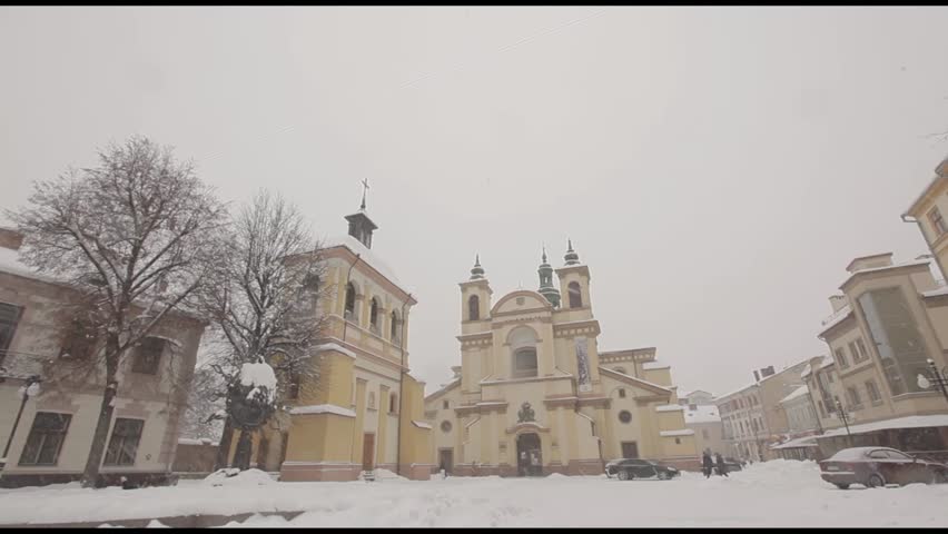 Beautiful Old Building in the City of Departure Snowing Chamber and Falls to the Ground Next to the Snow-Covered Streets of Structure Near the Temple Are the Street Lights , Ivano-Frankivsk, Ukraine