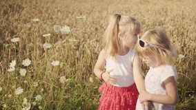 Two little girls take a walk through a forest park on a sunny summer day. Shoot on Digital Cinema Camera in hd.