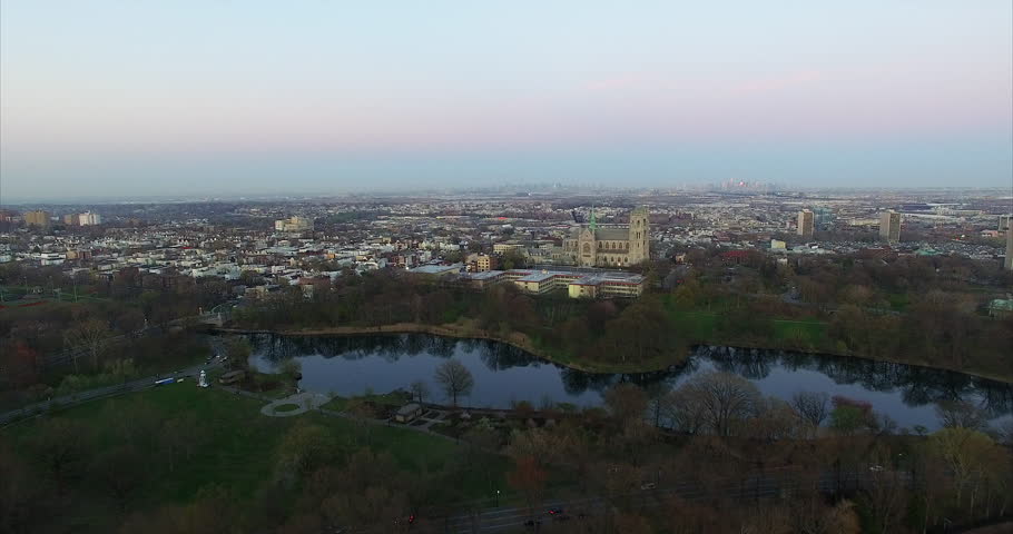 Twin-spired cathedral and Branch Brook Park lake at dusk in Newark.