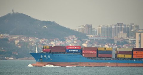 May 12,2016:4k Cargo Container Ships Through The QingDao Harbo,moder urban building,china. gh2_11324_4k