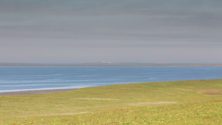 Russia, timelapse. The movement of clouds over the fields of winter wheat in early spring in the vast steppes of the Don.