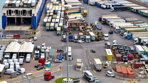 Salerno, Italy - April 21, 2016 timelapse view of an intersection of the commercial port of Salerno where trucks transiting to load the goods and containers to be loaded on ships.