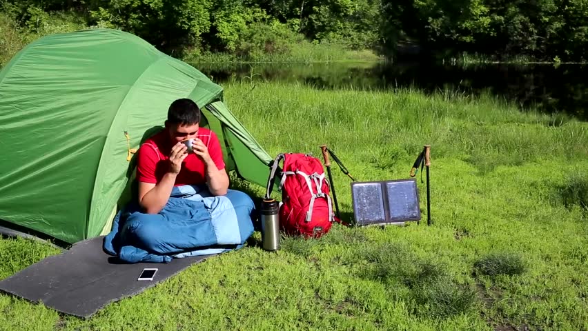 Man in camping in the woods in summer.