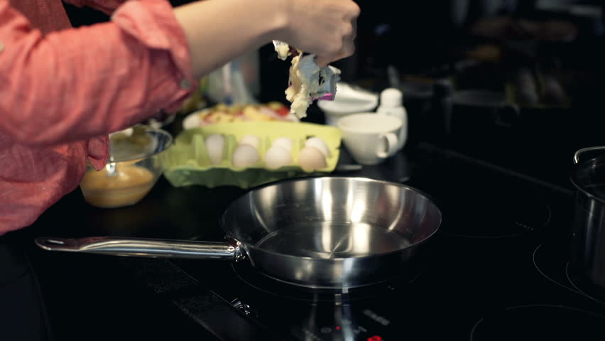 Woman hands cooking, putting butter on pan in the kitchen
