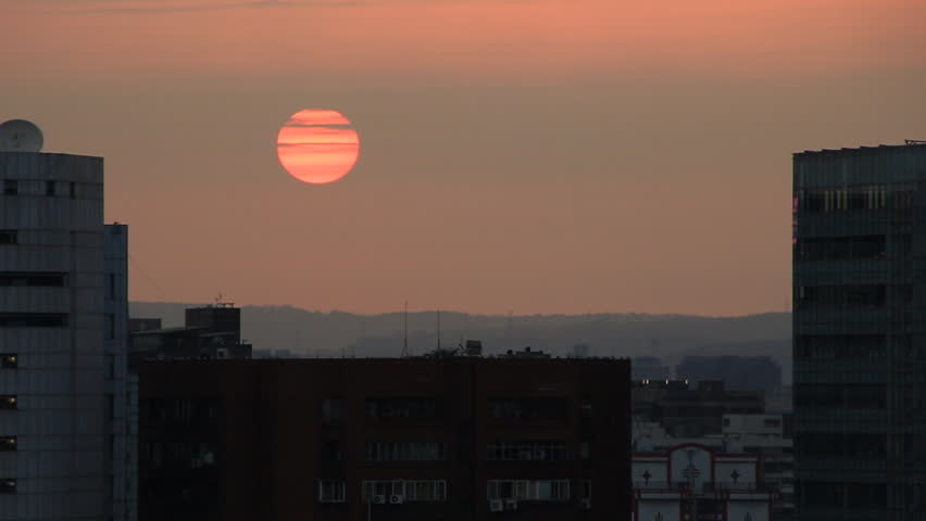 Beautiful view of an airplane flying over Taipei city at sunset