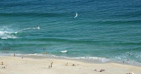 Waves At The Beach. Blue sea, blue sky. Kitesurfing, Kiteboarding, Surfers On Beach, Ocean. Rio de Janeiro, Brazil. 