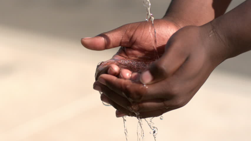 African American hands of child with water pouring into them slow motion Royalty-Free Stock Footage #16731982