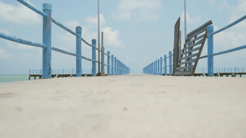 Man walking on the jetty with blue sky