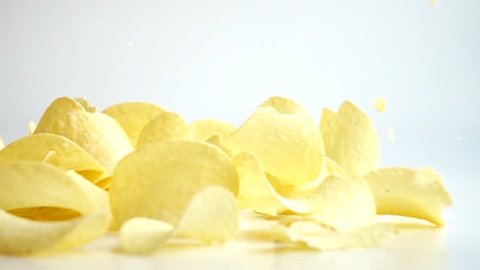 Falling Potato Chips against white background. Shot with high speed camera in slow motion.