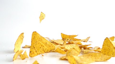 Falling Nachos against white background. Shot with high speed camera in slow motion.