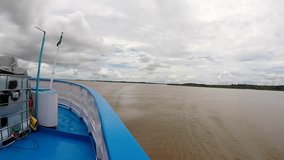 Front view of the passenger boat cruising on the Amazon river with loads of wind in Brazil
