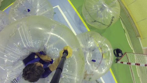 MOSCOW - SEP 23, 2015: Man in big ball falls (man with model release), New sport bumperball appeared in 2011 in Norway