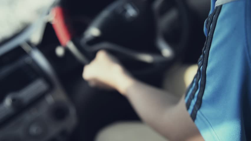 Unknown asian man in Blue sport shirts drives  his car from back by hold the wheel with motion and  vibration full HD
