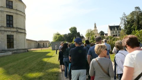 CHAMBORD, LOIR-ET-CHER, FRANCE - CIRCA 2016: Tourists in queue for tickets for the famous Chateau de Chambord one summer spring day with warm weather and blue sky