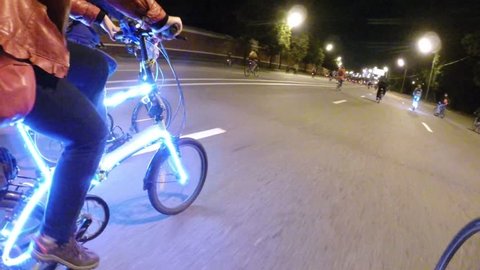 Many cyclists with illumination ride during Night Cycling Parade, FPV