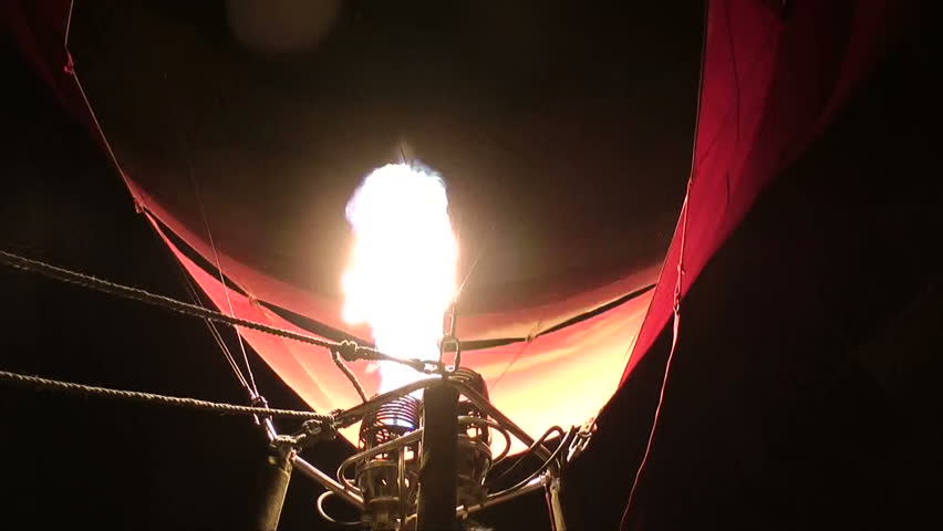 close-up of hot air balloon firing burner at night