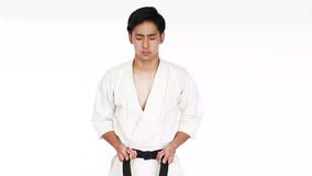 Young adult man with black belt practicing a Kata 

