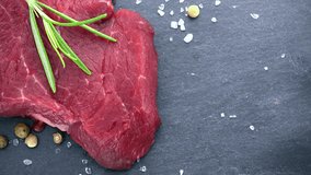 Portion of raw Beef fillet (not loopable; 4K)on wooden background