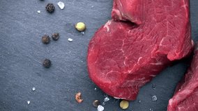 Rotating raw Beef fillet (seamless loopable; 4K) on wooden background