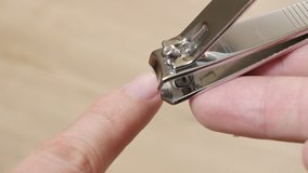 Nails and hands taking care with nail clipper hygiene 4K 3840X2160 UltraHD video - Close-up of trimming fingernails with nail trim shallow DOF 4K 2160p 30fps UHD footage