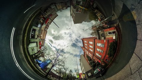 People Walk by City Street Among Buildings, Red Bricks Houses, vr Video 360, Little Planet Video, Video For Virtual Reality, Time Lapse, Road Markings, Cars Moving by Paved Road, White Clouds,
