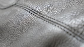 Black leather surface from clothing or footwear 4K 2160p 30fps UltraHD  tilting footage - Slow tilt over dark leather texture close-up 4K 3840X2160 UHD video