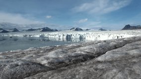 Panorama glacier on the border with the ocean.  Fantastic wonderful amazing video grenland nature iceland and Arctic. Lovely shooting the life of nature, seaside and mountains. Global warming.