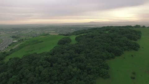 4K aerial drone shot hills trees forward sunset