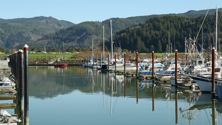 Garibaldi Marina, Oregon. Boaters pass in the marina on Tillamook Bay in Garibaldi, Oregon. Pacific Northwest. United States.


