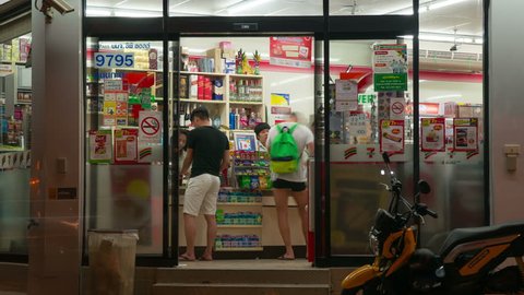 Phuket, Thailand - May 10, 2016: Time Lapse Seven Eleven store building exterior open and closed doors