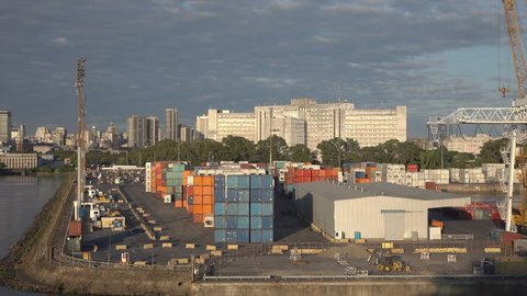 BUENOS AIRES, ARGENTINA - FEBRUARY 12, 2016: Dolly shot of the container port and skyline behind. The Port of Buenos Aires or Puerto Nuevo handles around 11 million metric tons of cargo annually.