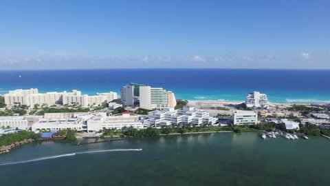 Aerial view of Lagoon and Caribbean Ocean Showing recreation speed boats Cancun Resorts Hotels Shopping Mall and beach