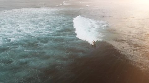 Aerial view of huge ocean waves and surfing in Bali indonesia
