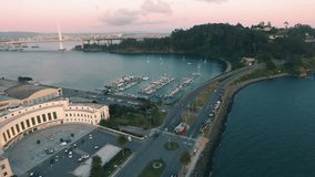 4K Aerial drone shot San Francisco going down treasure island boats