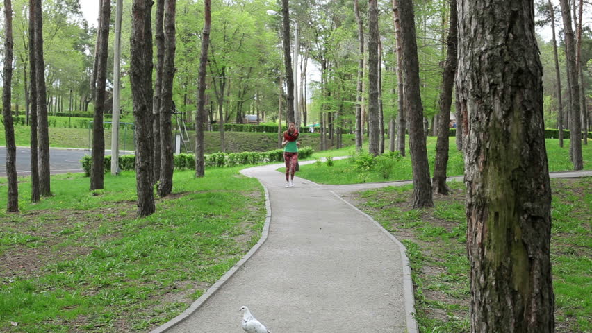 The beautiful young girl jogging in the park.