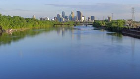 Minneapolis Skyline Reflection Against Rushing Mississippi River and Early Spring Canoers 4K UHD Timelapse